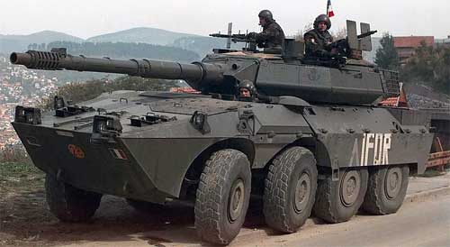 An IFOR marked Italian Army 19th Cavalry Regiment Consortium IVECO - OTO Melara Centauro B1 (8x8) Tank Destroyer is parked on the shoulder of a road while on patrol in Sarajevo, Bosnia-Herzegovina. Three crewmembers are seen standing up through the two turret hatches and the driver's hatch. The Italian Army is in Bosnia during Operation Joint Endeavor, which is a peacekeeping effort by a multinational Implementation Force (IFOR), comprised of NATO and non-NATO military forces, deployed to Bosnia in support of the Dayton Peace Accords B1, "Чентауро" (итал. Centauro — "Кентавр")